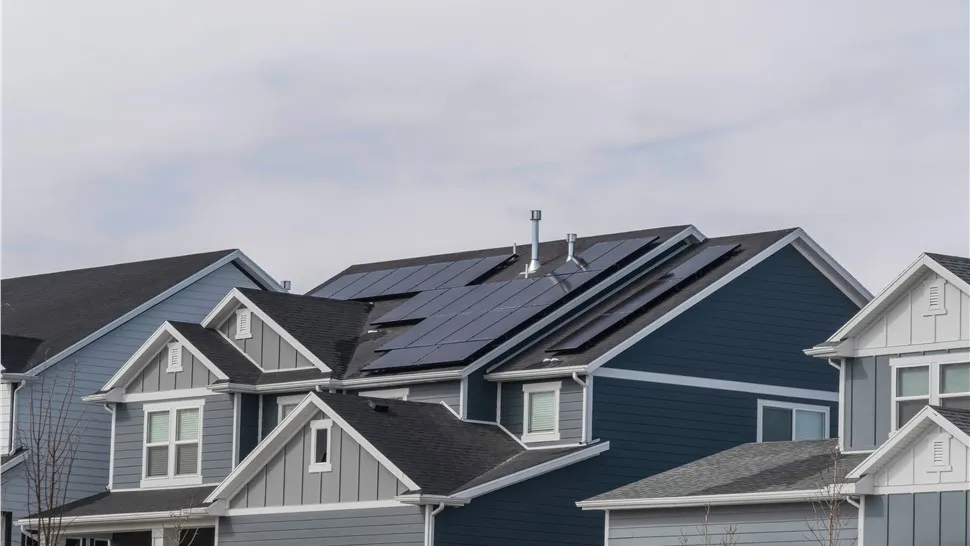 Solar panel arrays on the roofs of neighboring homes