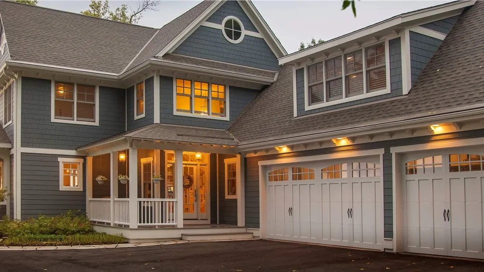 Home with gray siding and white trim at dusk