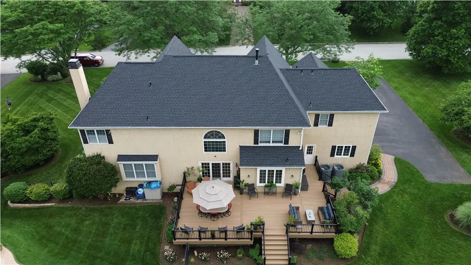 Rear elevation of a home with arched and double-hung windows