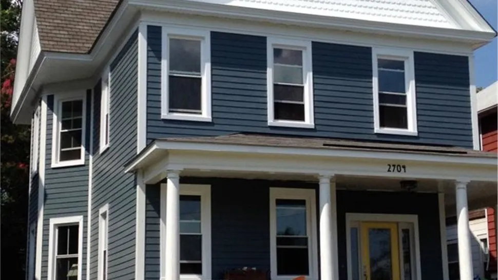 Two-story home with blue lap siding and white trim